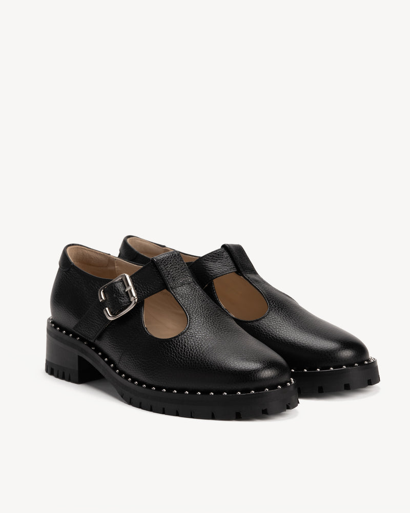 Angled view of The Academy Mary Jane Black in pebbled leather. Sizes 5–12