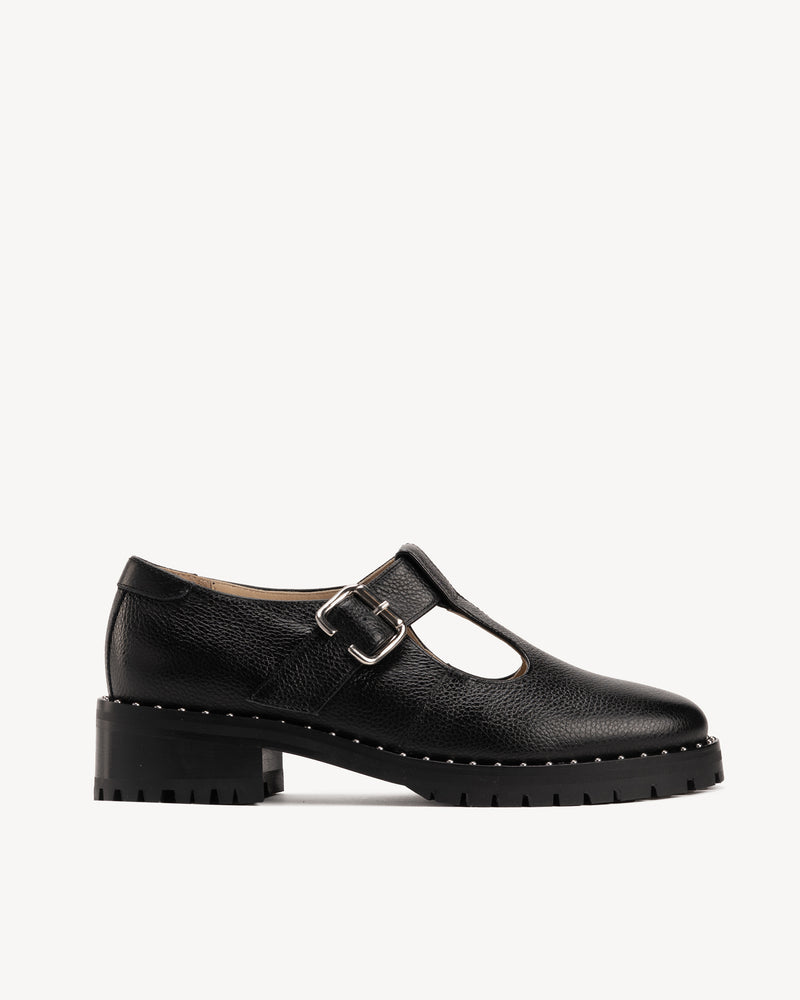 Side view of The Academy Mary Jane Black in pebbled leather. Sizes 5–12