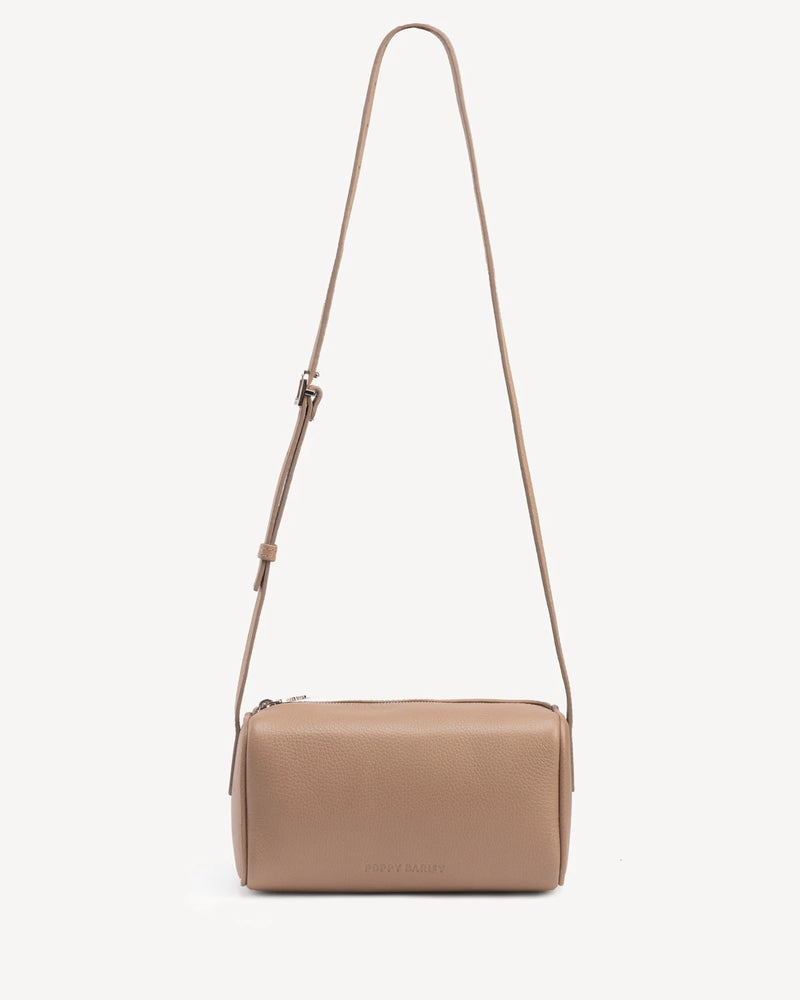 Cylindrical barrel bag with long adjustable crossbody strap. The Annex Bag Biscotti.