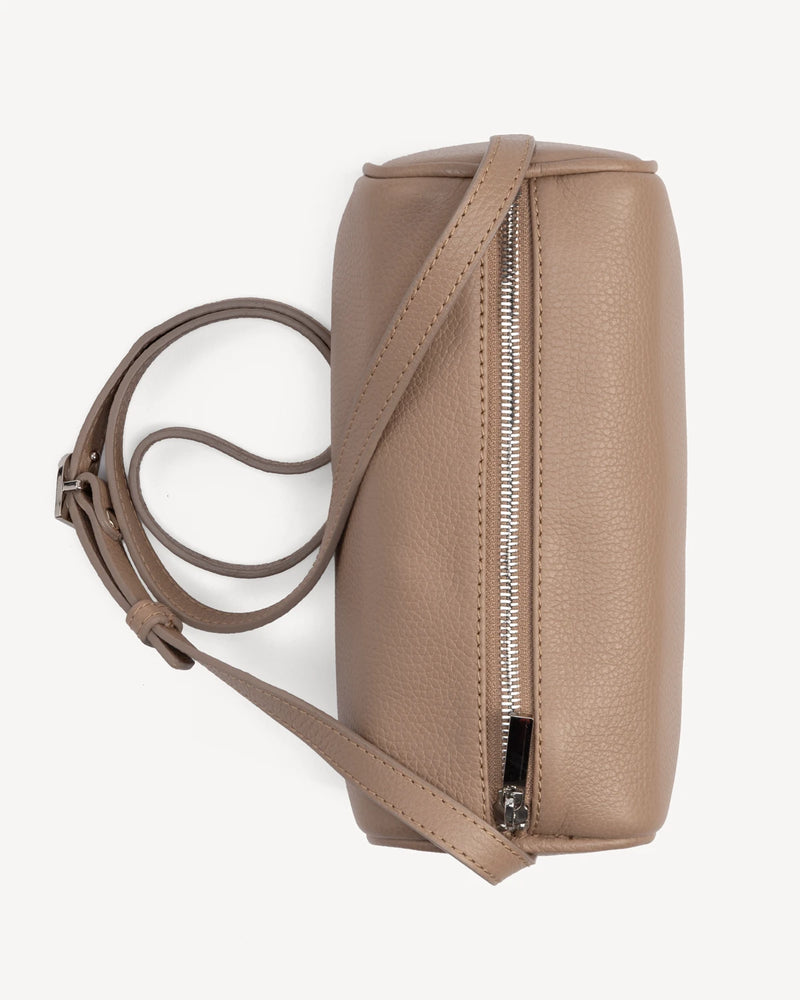 Side view of cylindrical barrel bag showing zip closure and strap. The Annex Bag Biscotti.