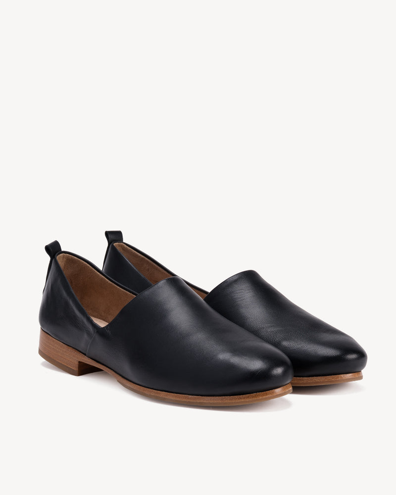Angled view of The At-Leisure Slip-On 2.0 Black in smooth leather. Sizes 5–12, wide available