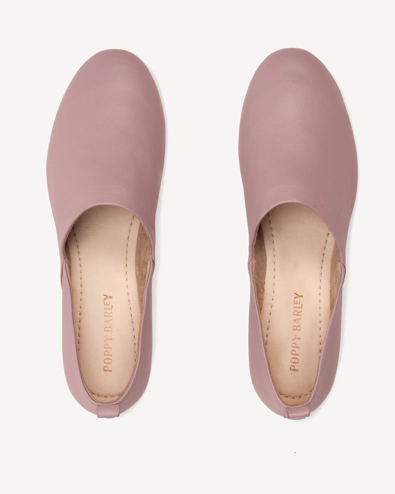 Top-down view of both flats with a smooth square toe. The At-Leisure Slip-On 2.0 Dusty Mauve. Sizes 5–12, wide available.