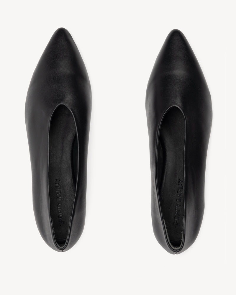 Flat lay of The Atelier Flat Black in smooth leather. Sizes 5–12, wide available