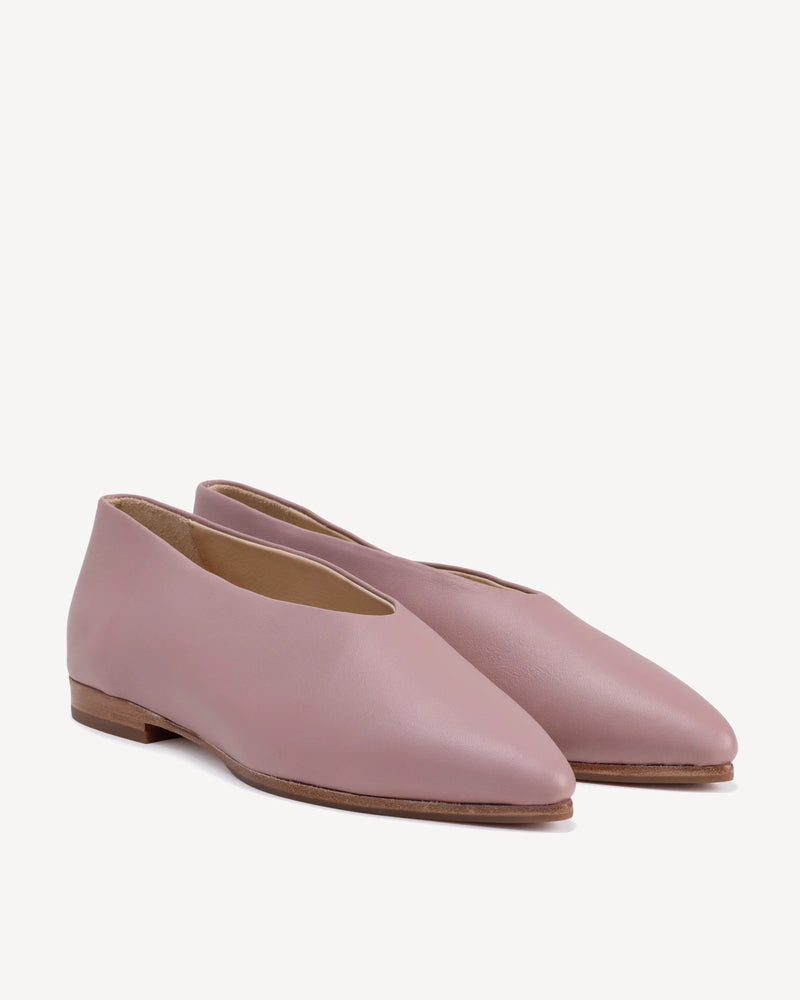 Angled pair view highlighting the soft V-cut vamp and sleek silhouette. The Atelier Flat Dusty Mauve. Sizes 5–12.