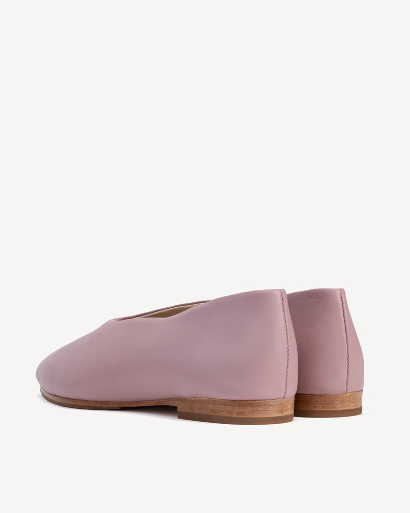Back view of the pair showing the heel counter and stitched seam. The Atelier Flat Dusty Mauve. Sizes 5–12.
