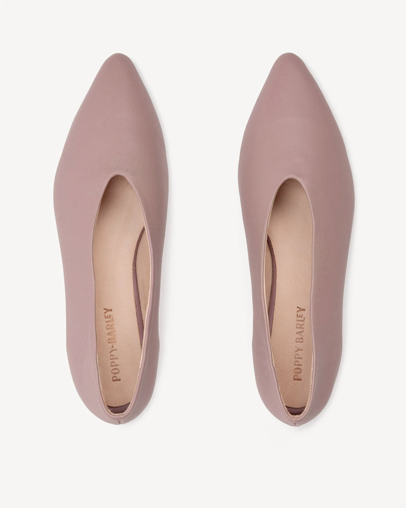 Top-down view of the pair showing the sleek pointed toe shape. The Atelier Flat Dusty Mauve. Sizes 5–12.