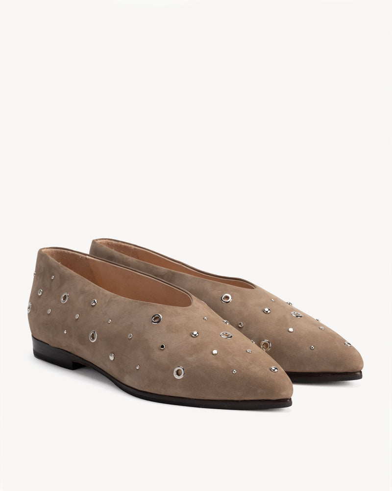 Flat lay of The Atelier Flat Clay Studded in Neutral nubuck. Sizes 5–12, wide available