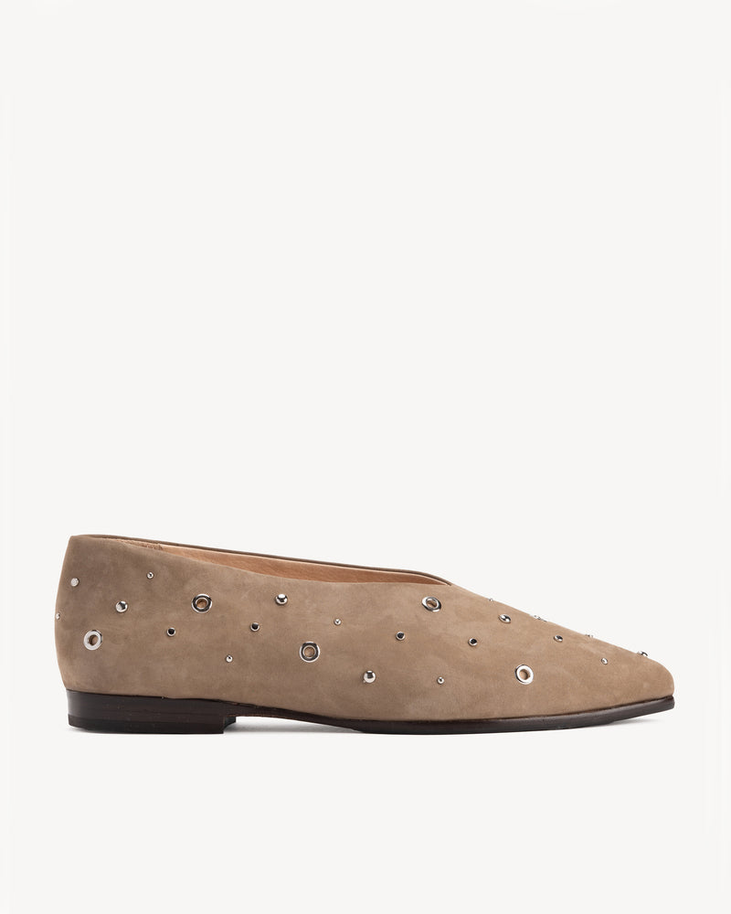 Flat lay of The Atelier Flat Clay Studded in Neutral nubuck. Sizes 5–12, wide available