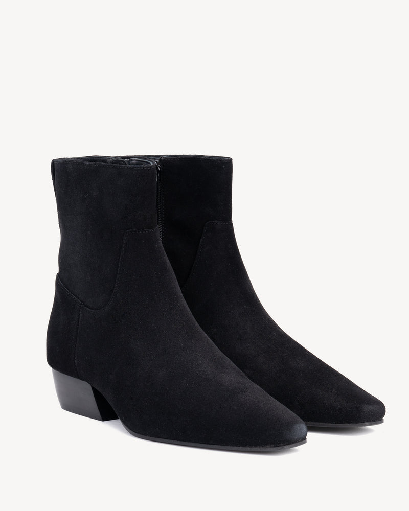 Angled view of The Beau Boot Black in suede. Sizes 5–12