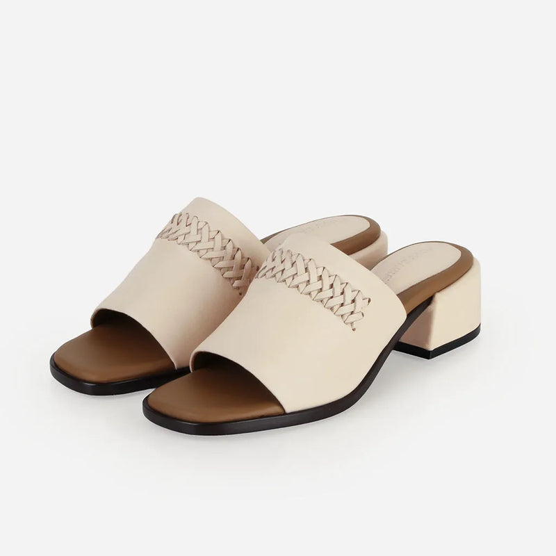 Pair of The Bohème Heeled Sandal Oat Milk in White smooth leather. Sizes 5–12, wide available