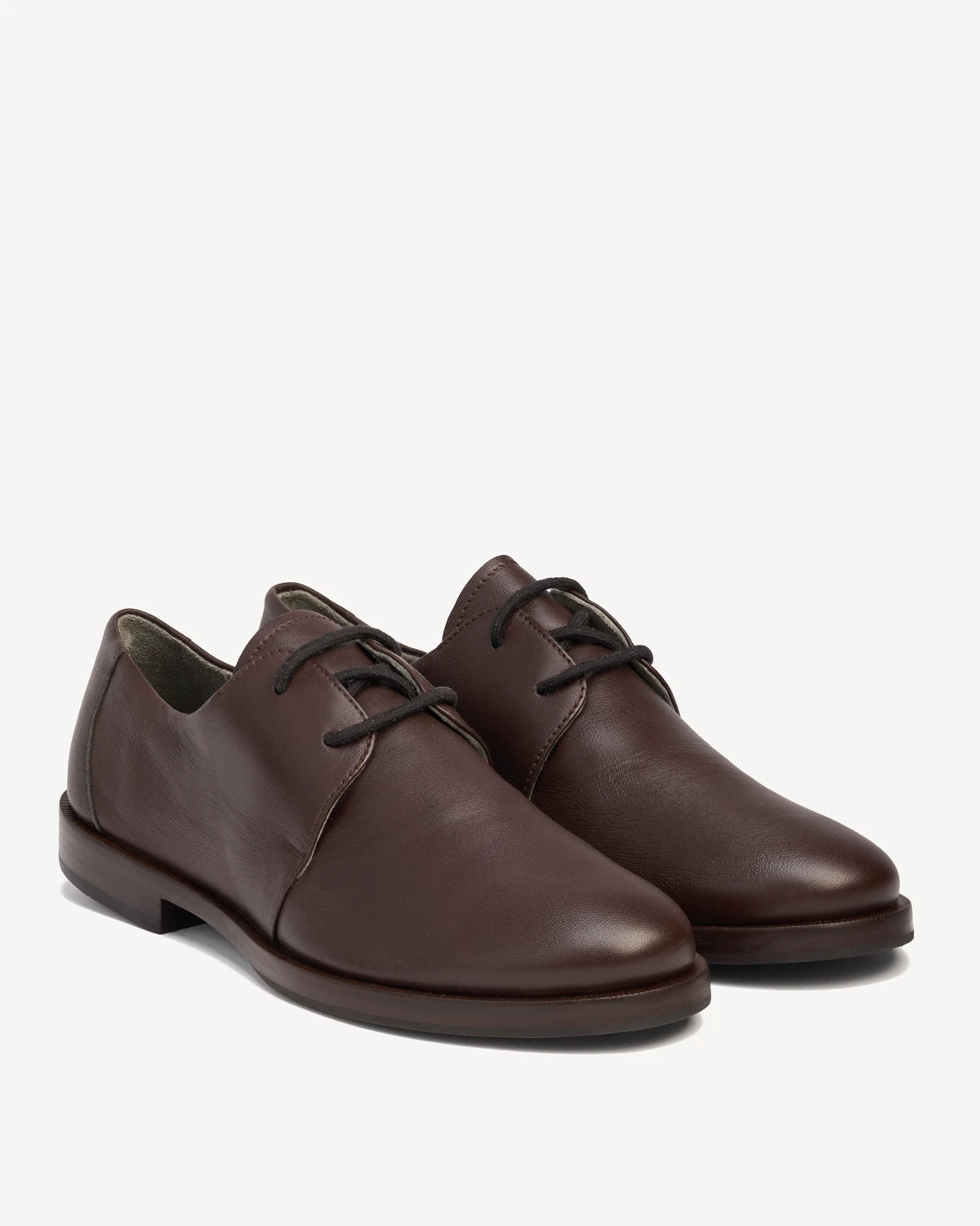 Pair of leather lace-up oxfords at a front angle. The Capsule Oxford Cocoa Plum. Sizes 5–12, wide available.