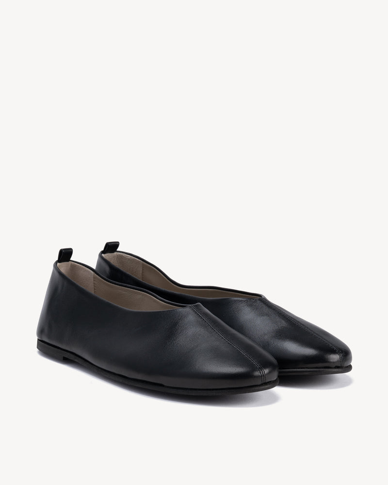 Angled view of The Contemporary Ballet Flat Black in smooth leather. Sizes 5–12