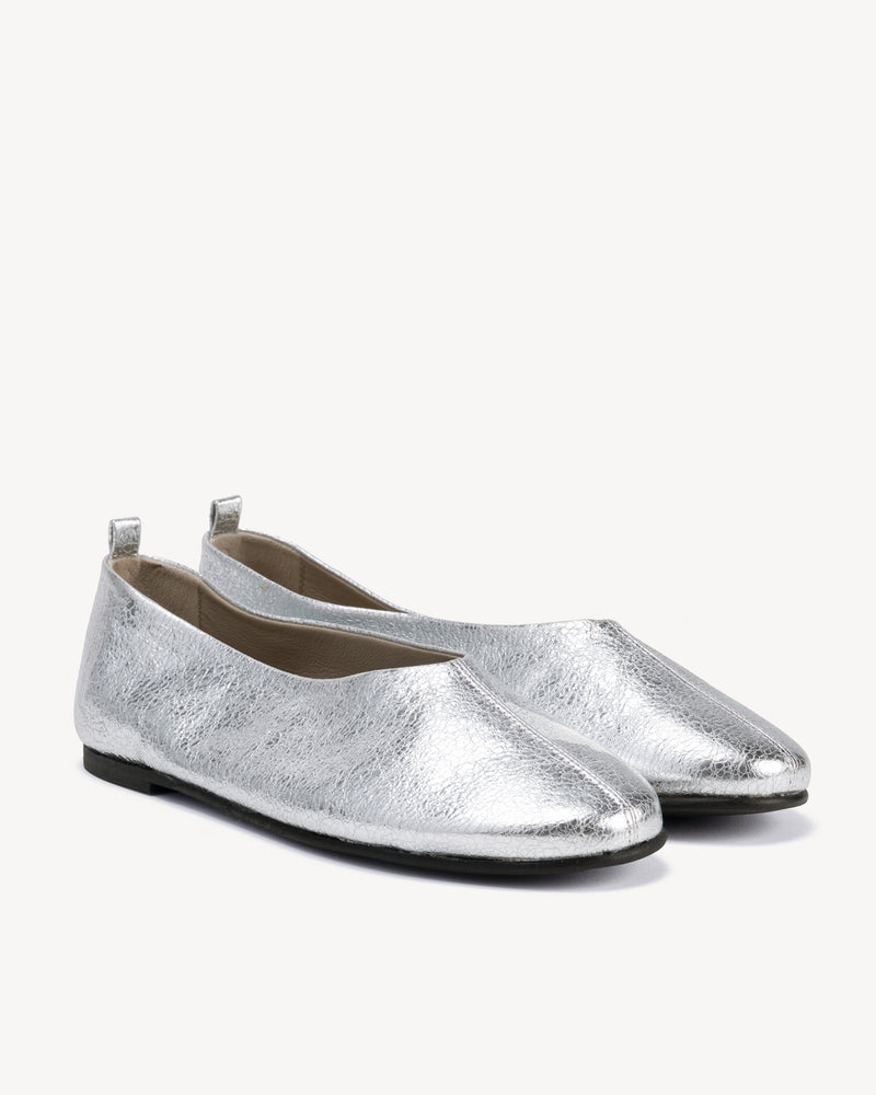 Angled view of The Contemporary Ballet Flat Silver in Metallic leather. Sizes 5–12