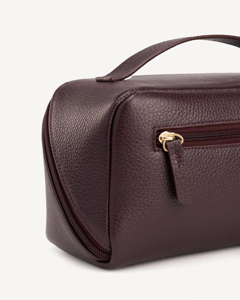 Close-up detail of The Cosmetic Case Large Plum in Purple pebbled leather