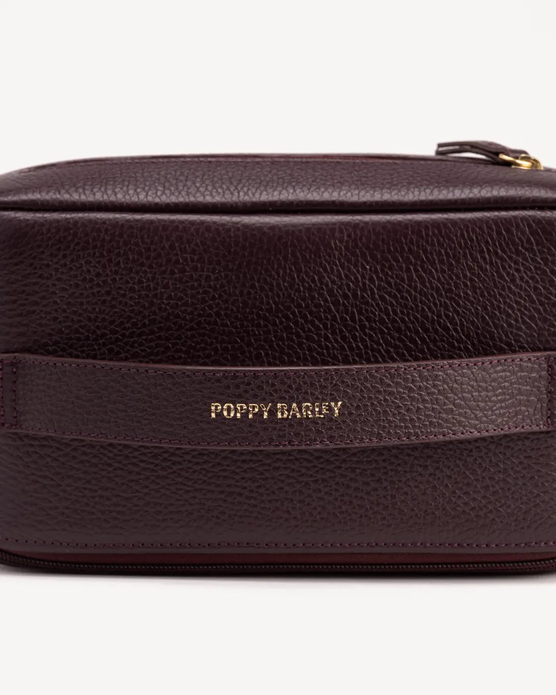 Close-up detail of The Cosmetic Case Large Plum in Purple pebbled leather