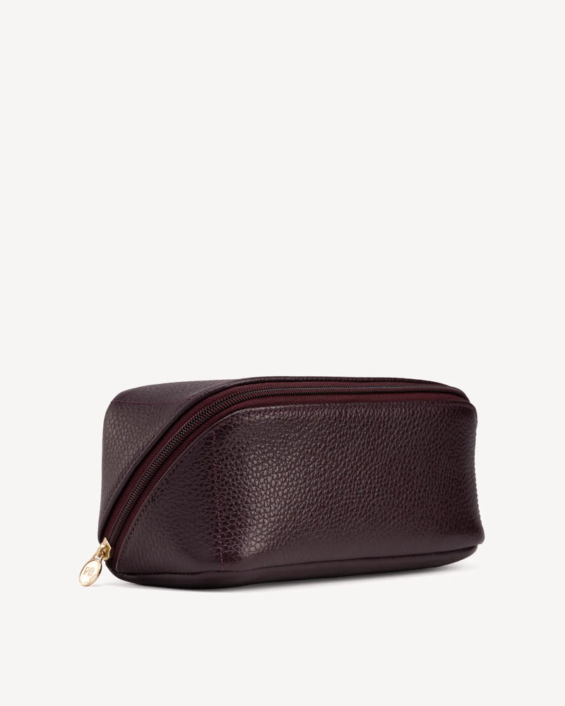 Angled view of The Cosmetic Case Small Plum in Purple pebbled leather