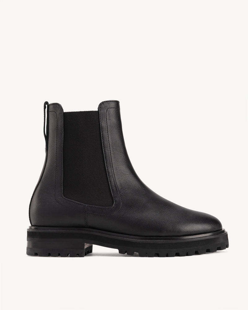 Side view of The Every Way Chelsea Boot Black Water Resistant in Black smooth leather. Sizes 5–12, wide available