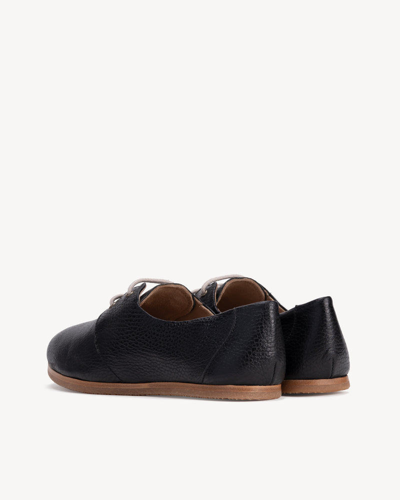 Back view of The Eyelet Oxford 2.0 Black Pebble in pebbled leather. Sizes 5–12, wide available