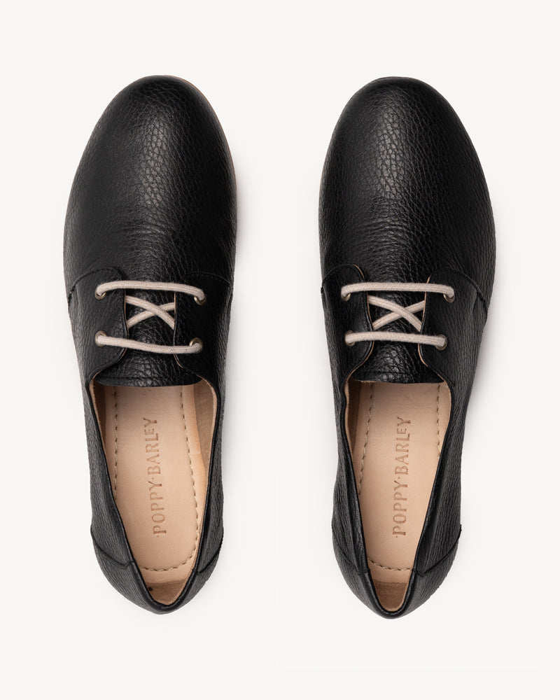 The Eyelet Oxford 2.0 Black Pebble in pebbled leather. Sizes 5–12, wide available