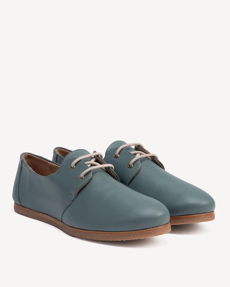 Angled pair of lace-up oxford flats. The Eyelet Oxford 2.0 Storm. Sizes 5–12, wide available.