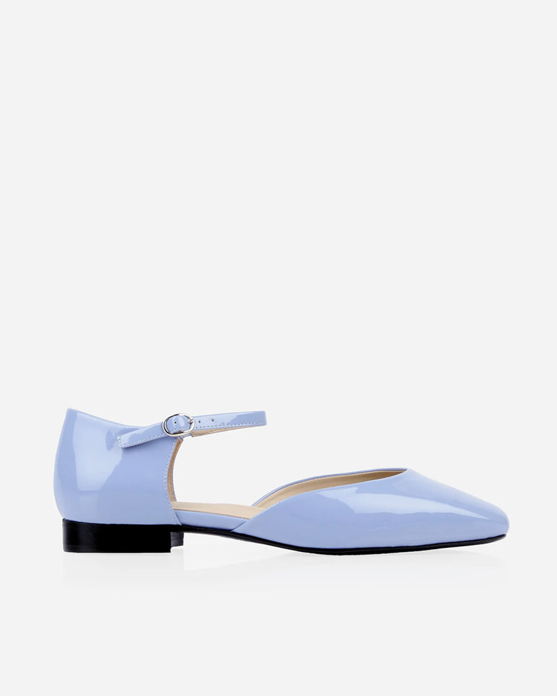 Side profile in glossy patent leather with d'orsay cut, square toe. The Gallery Mary Jane Cornflower Patent. Sizes 5–12.