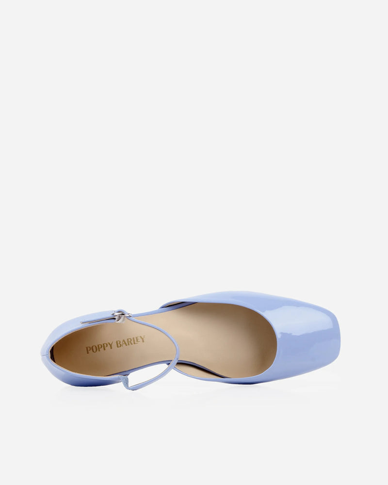 Side view of the pair showing the heel and buckle detail. The Gallery Mary Jane Cornflower Patent. Sizes 5–12.
