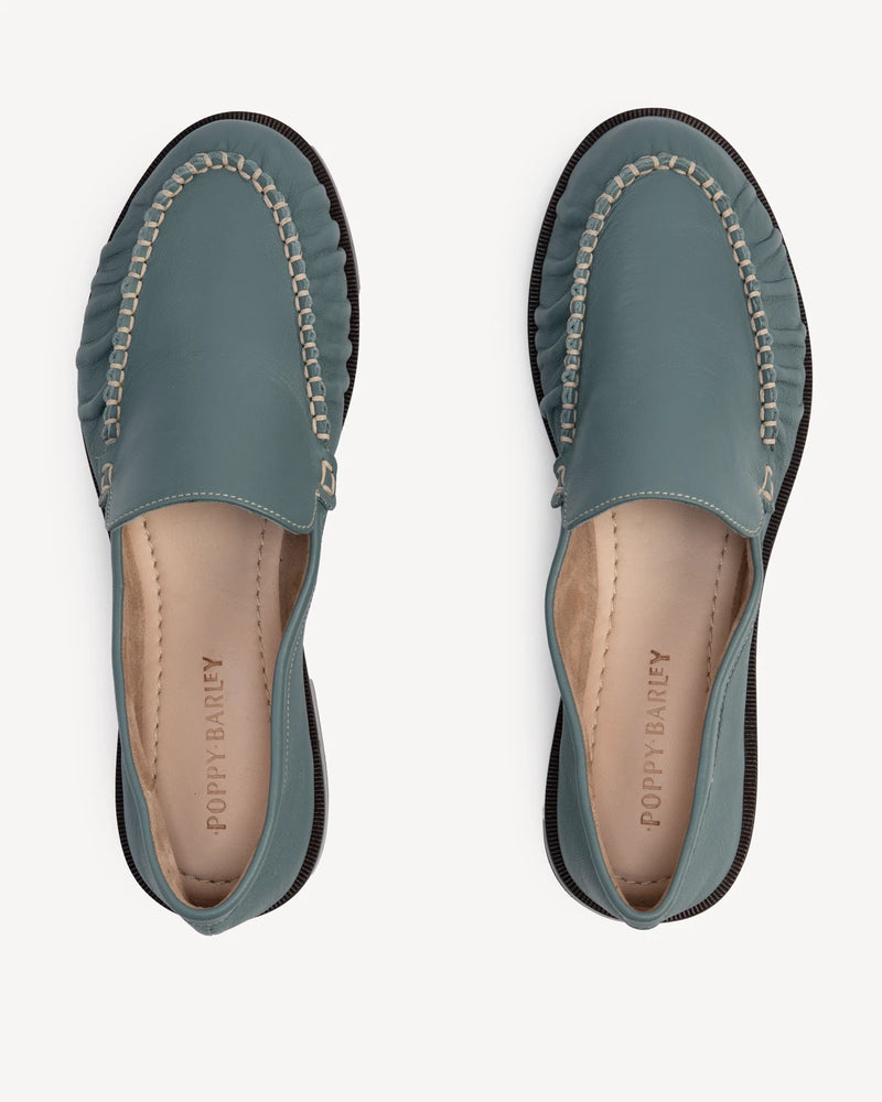 Overhead view of slip-on loafers with chain-trim vamp. The Laid Back Loafer Storm. Sizes 5–12, wide available.