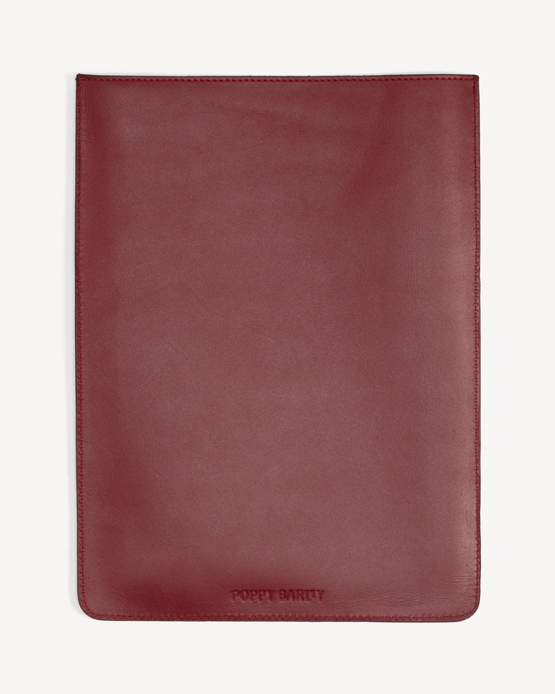Front view of a flat rectangular leather laptop sleeve with brand embossing. The Laptop Sleeve Resort Red.