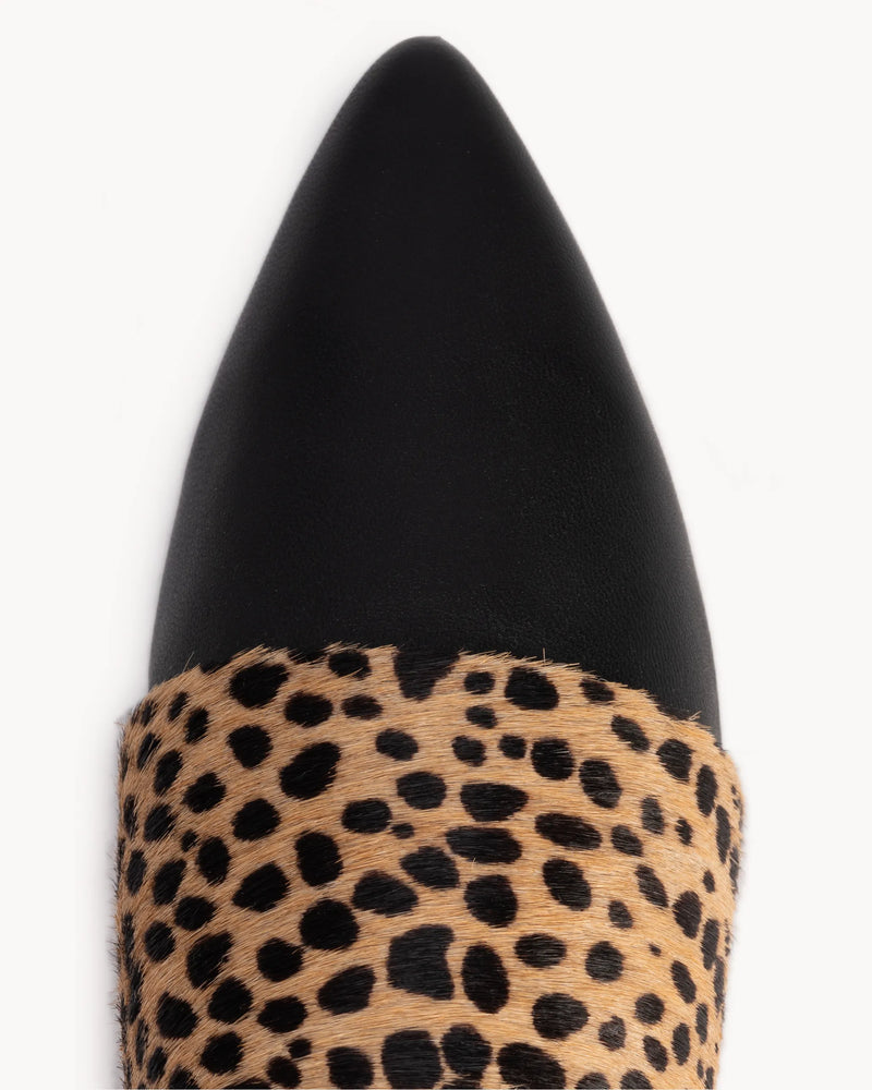 Close-up of pointed toe and calf hair band detail. The Luxe Fit Flat Black and Cheetah Calf Hair. Sizes 5–12, wide available.