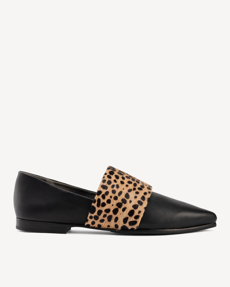 Pointed-toe flat with calf hair band, side view. The Luxe Fit Flat Black and Cheetah Calf Hair. Sizes 5–12, wide available.