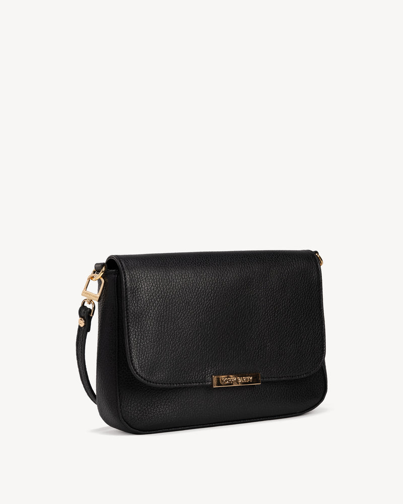 Angled view of The Medium Day to Night Bag Black Pebble in leather