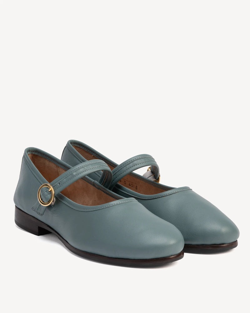 Angled pair of round-toe flats with single buckle strap. The Modern Day Mary Jane Storm. Sizes 5–12.