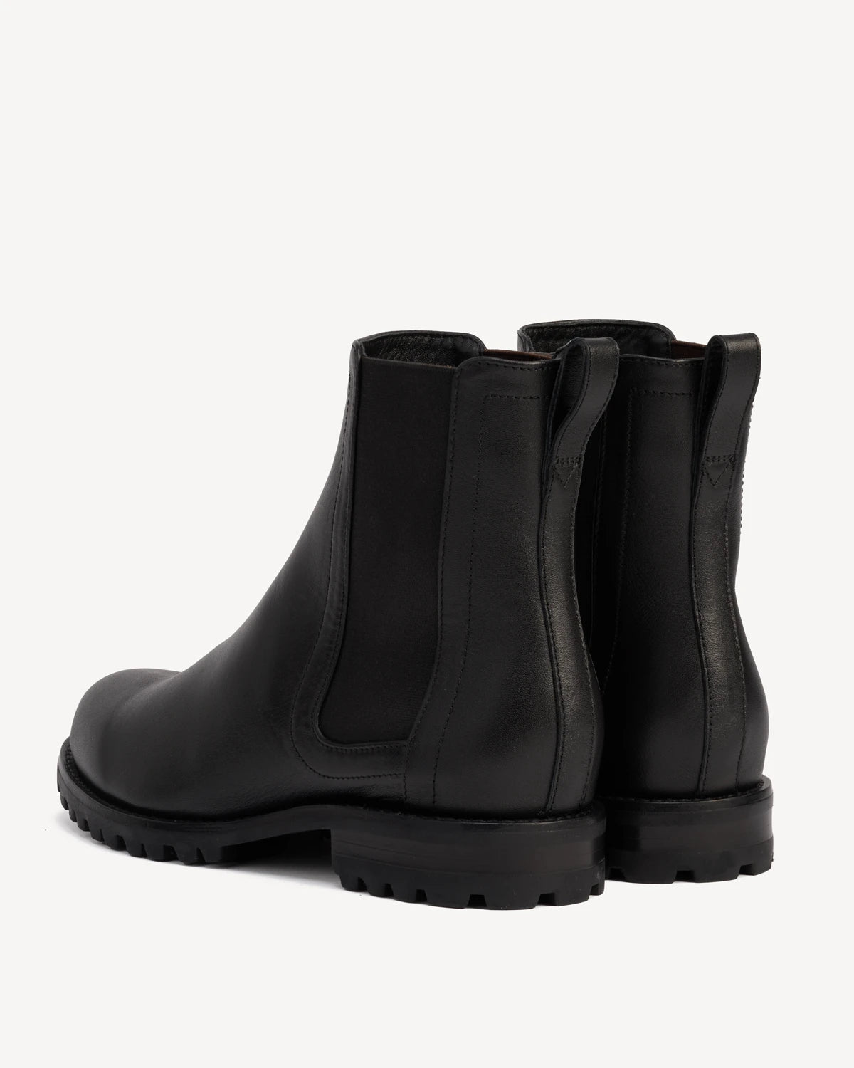 Angled view of a pair of Chelsea boots. The On Tread Chelsea Boot Black Water Resistant. Sizes 5–12, wide available.