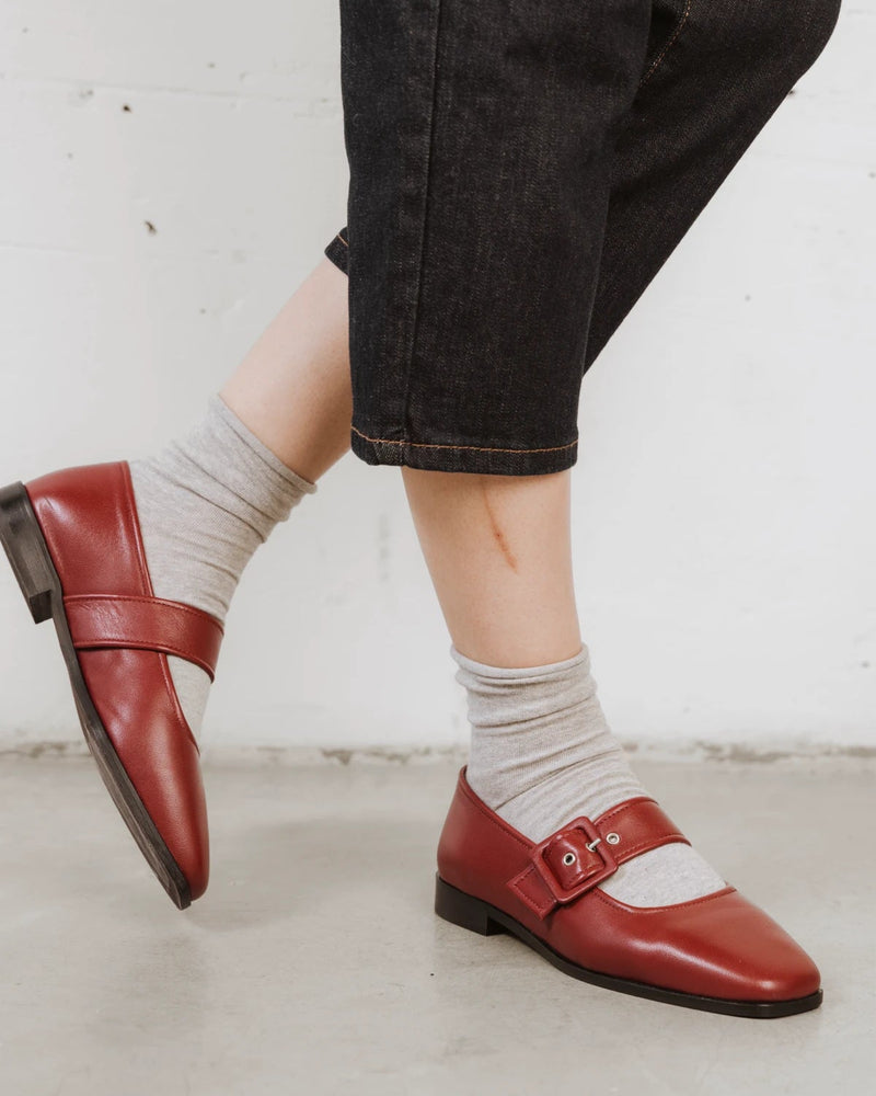 Close-up of a hand smoothing the ribbed cuff of a cotton-rich sock. The Daily Mid Crew Sock Grey Melange.