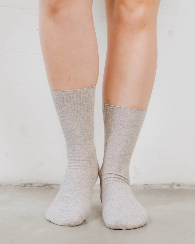 Front view of feet in ribbed crew socks with a folded cuff. The Ribbed Crew Sock Grey Melange.