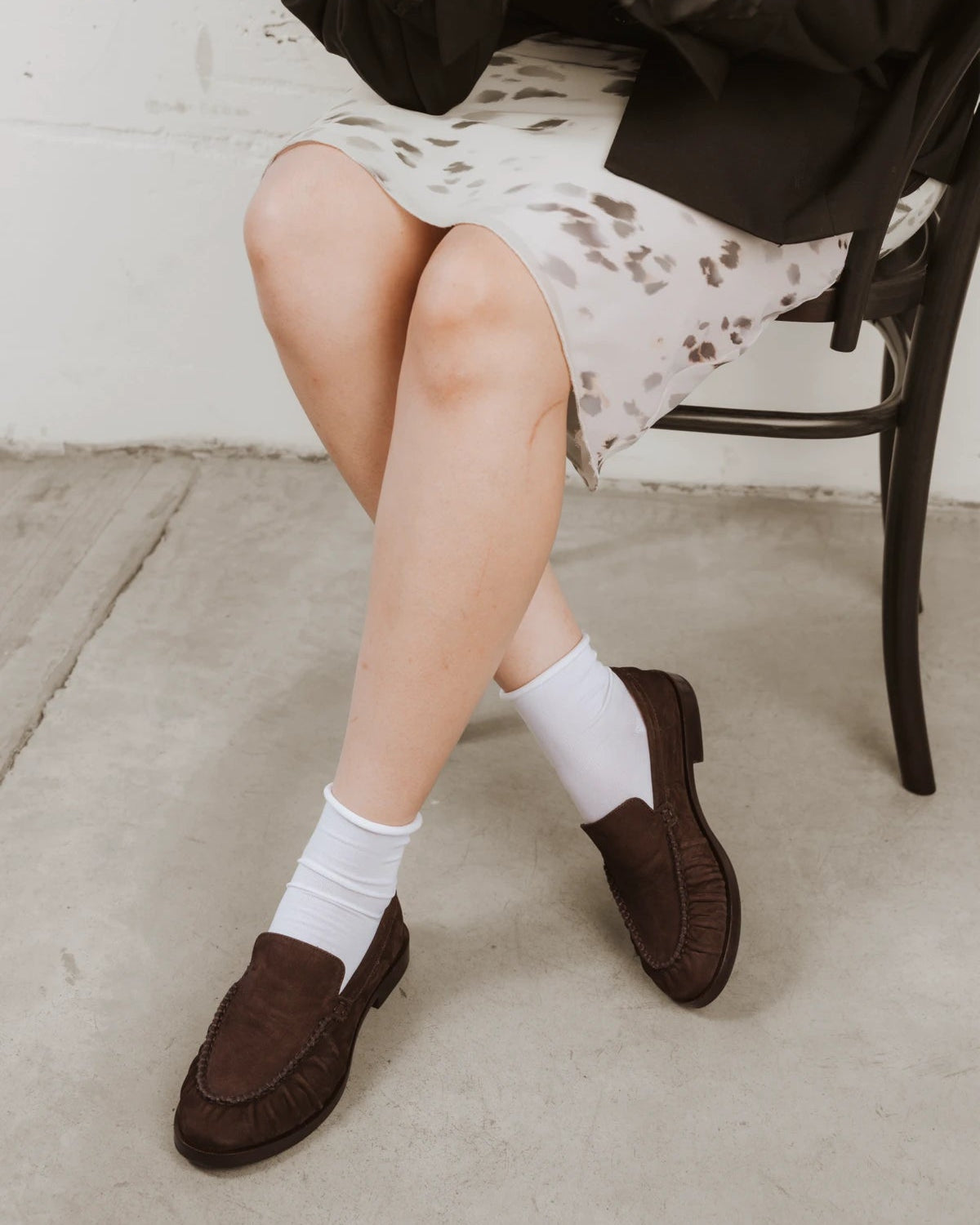 Styled on-foot with brown suede loafers beneath a patterned skirt. The Daily Mid Crew Sock White 3-Pack.