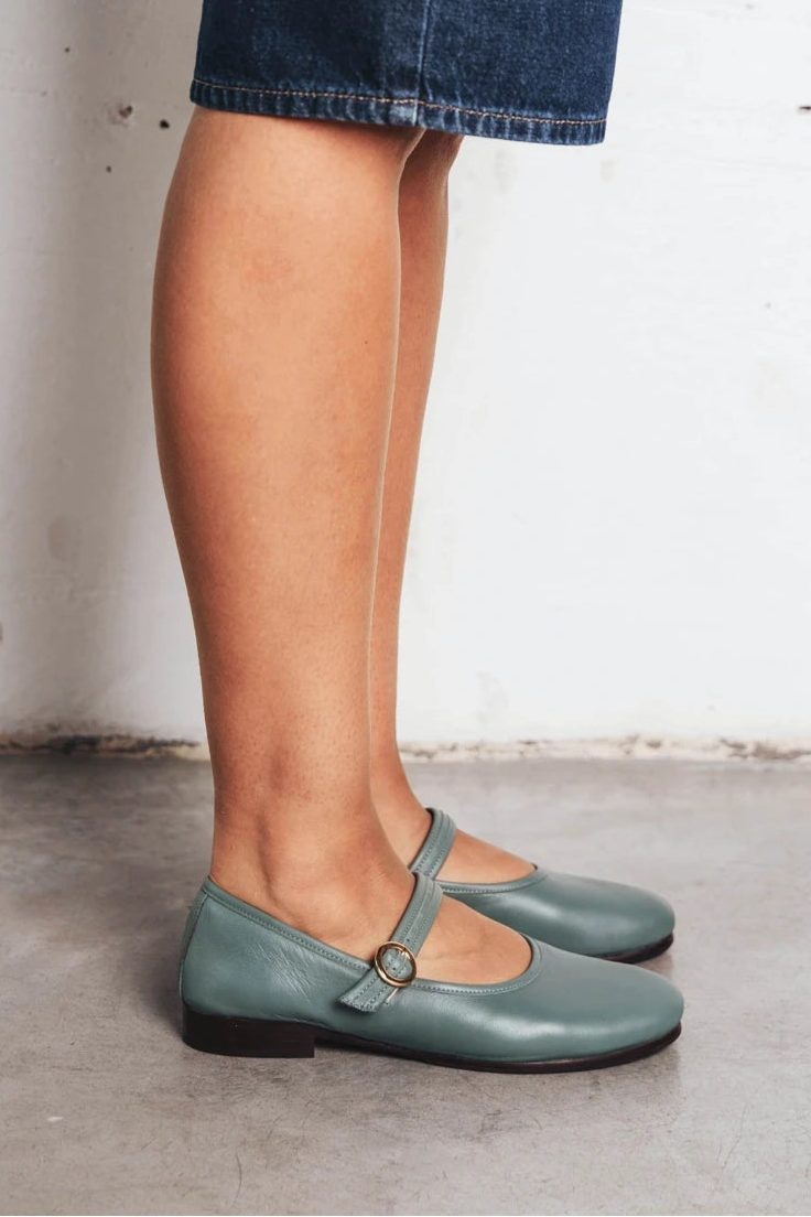 Model's leg shown wearing round-toe flats with single strap. The Modern Day Mary Jane Storm. Sizes 5–12.