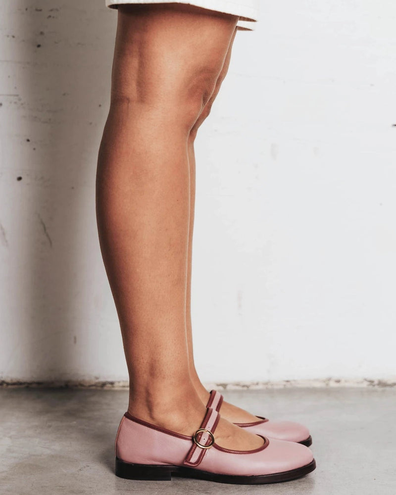 Model's leg shown wearing round-toe flats with single strap. The Today Mary Jane Dusty Mauve. Sizes 5–12.