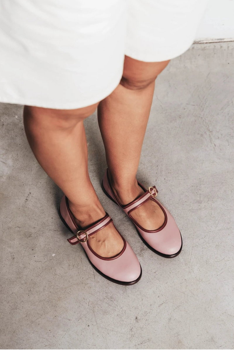 Feet shown wearing round-toe flats with single buckle strap. The Today Mary Jane Dusty Mauve. Sizes 5–12.