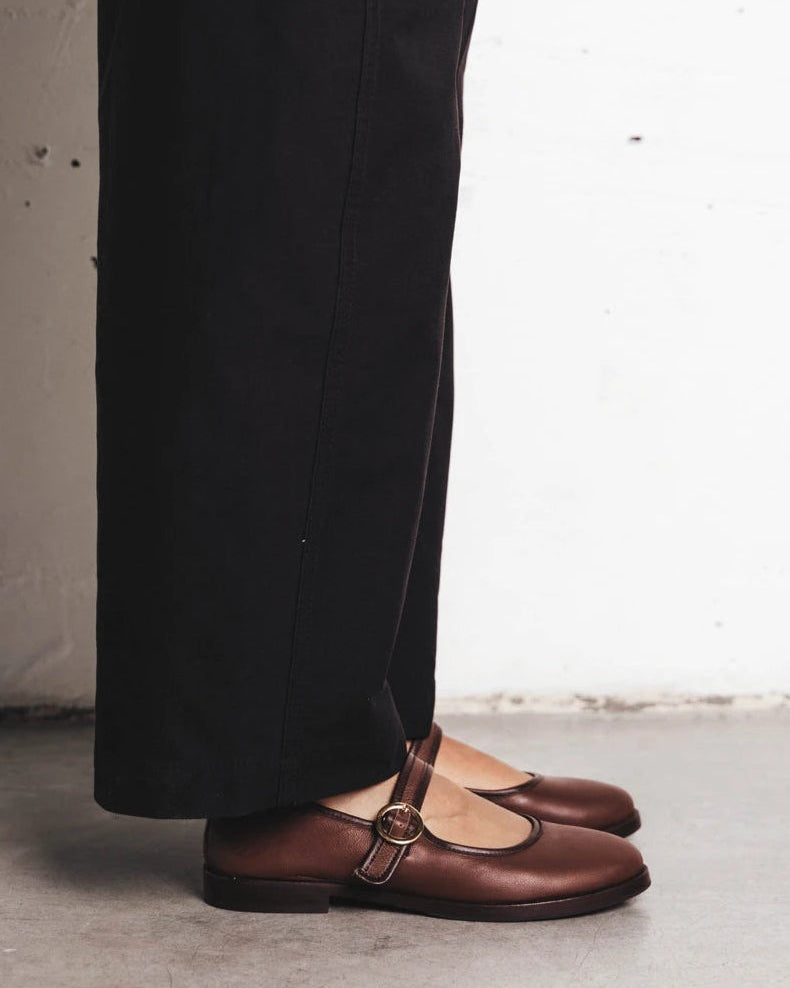 Model's leg shown wearing round-toe flats with single strap. The Today Mary Jane French Press. Sizes 5–12.