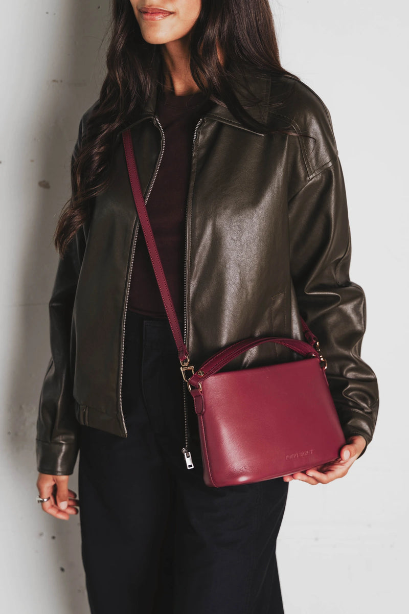 Bag worn crossbody over the shoulder. The Via Monte Bag Compote.