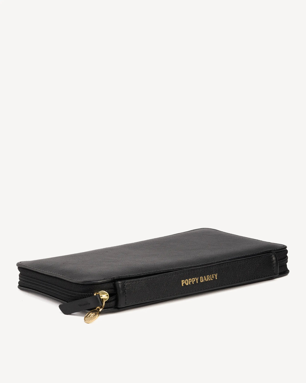 Side view of the zip-around passport holder with embossed logo. The Six Person Passport holder & Slim Luggage Tag Set Black.