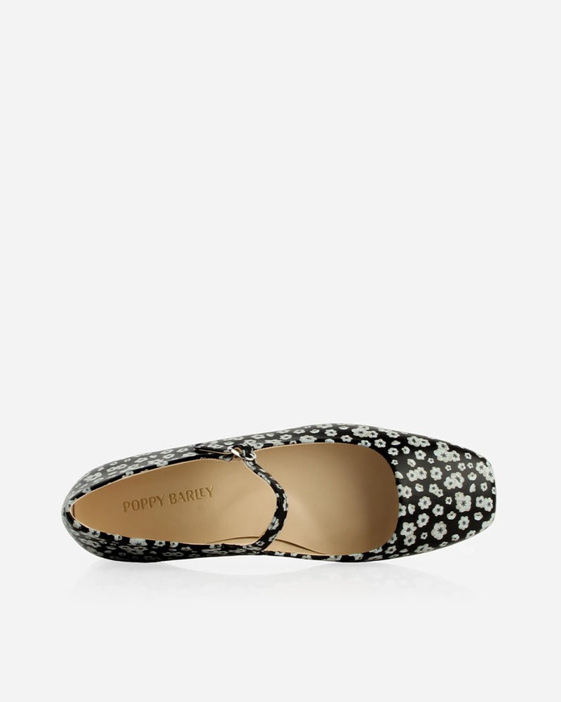 Overhead close-up of the buckle and strap on the toe box. The Studio Mary Jane Moonflower. Sizes 5–12.