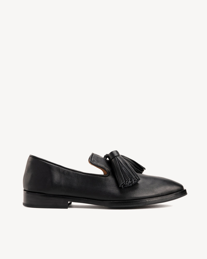 Side view of The Tassel Daily Loafer Black in smooth leather. Sizes 5–12, wide available
