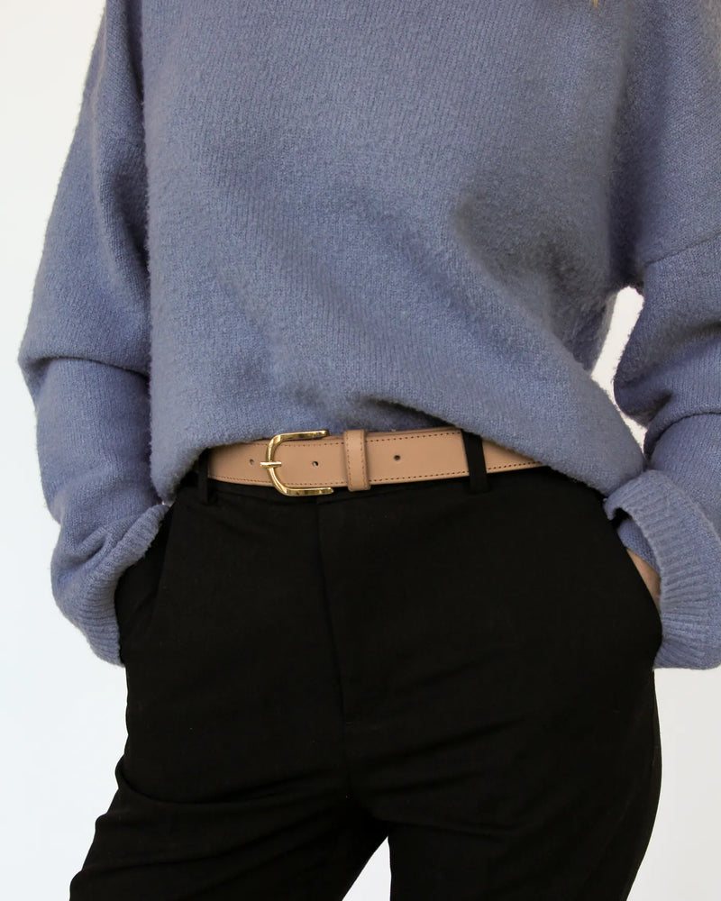 Biscotti leather belt with gold buckle, styled with black trousers and blue knit sweater. The Accent Belt Gold Biscotti.