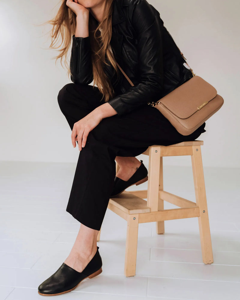 Leather slip-on shoes on woman trousers. The At-Leisure Slip-On 2.0 Black. Sizes 5–12, available in wide.