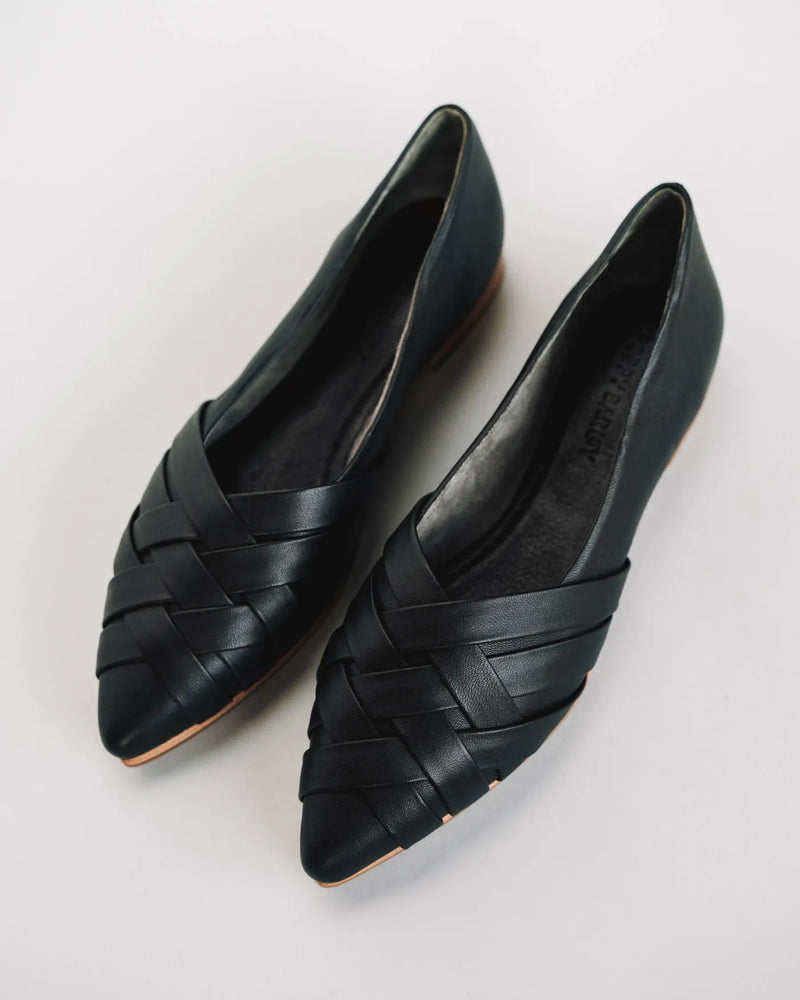 Woven leather pointed-toe flats, overhead view on white surface. The Athena Flat Black. Sizes 5–12.