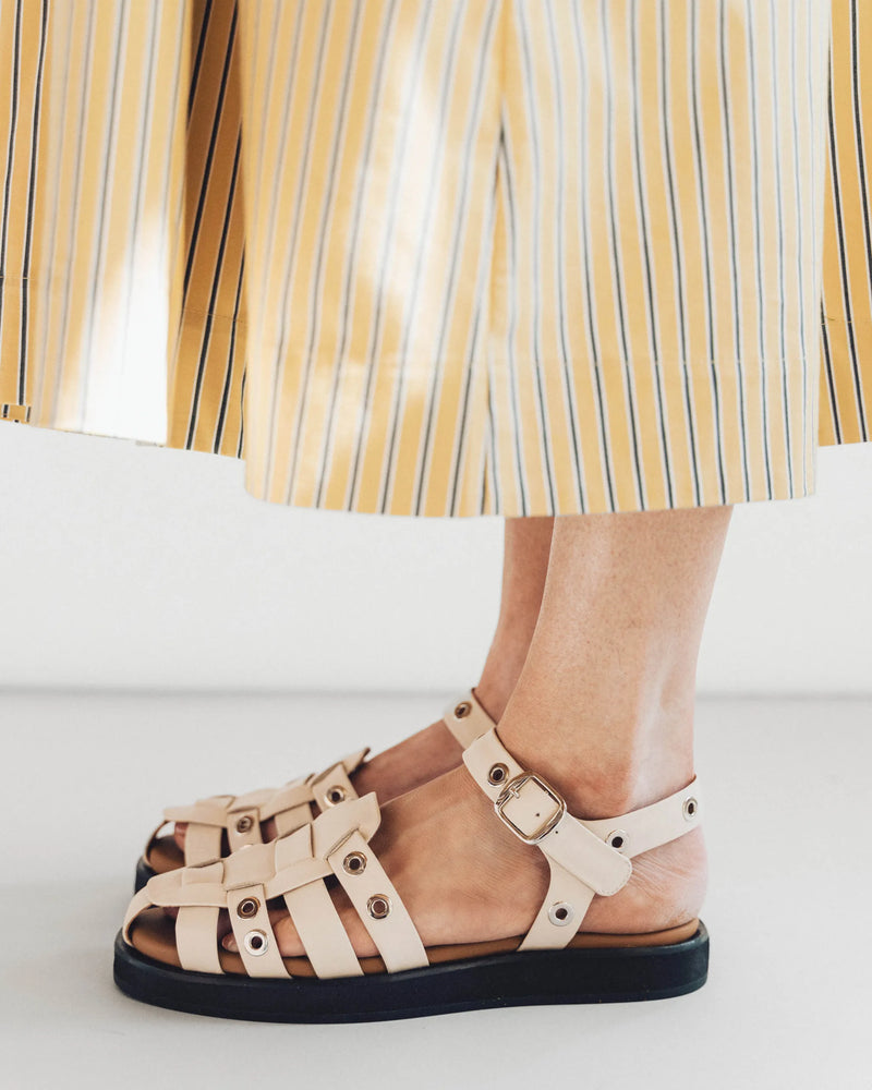 Oat milk and silver cage sandals with ankle strap, side view. The Beachcomber Sandal Oat Milk and Silver. Sizes 5–12.