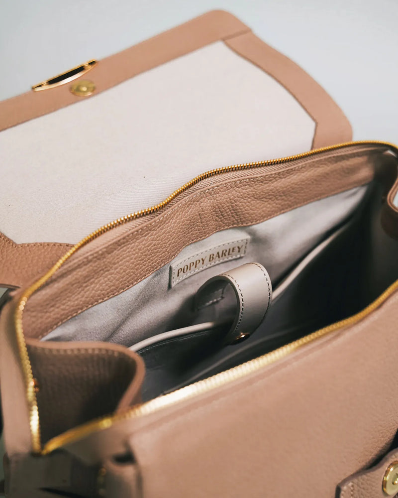 Interior view of the main compartment with Poppy Barley branding inside. The Beyond Backpack Biscotti.