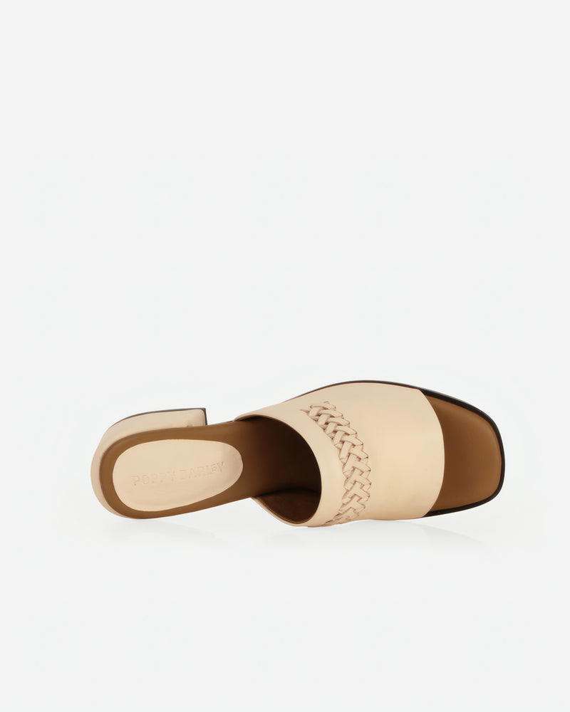 Overhead view of heeled slide sandal showing woven strap and open toe. The Bohème Heeled Sandal Oat Milk. Sizes 5–12.